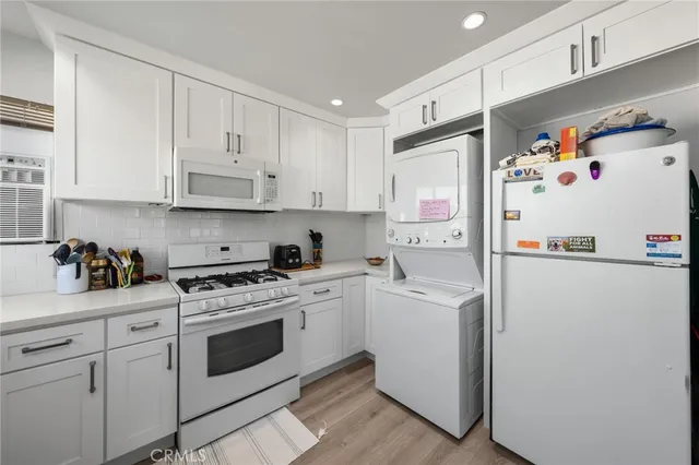 a white refrigerator freezer sitting inside of a kitchen