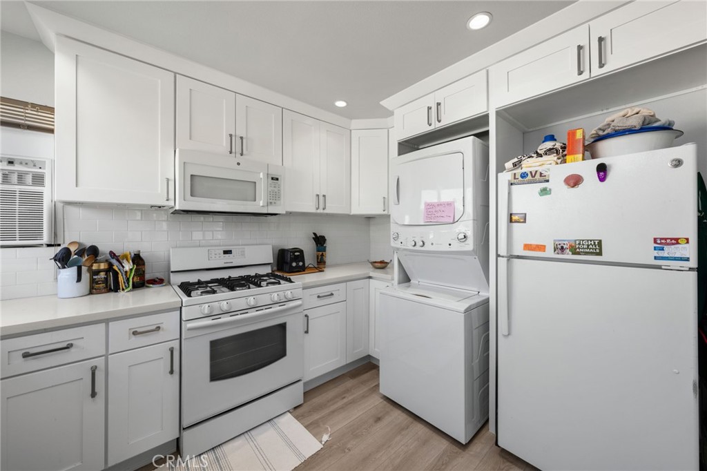 3754 California Long Beach, CA 90807 - Photo 29 of 38 a white refrigerator freezer sitting inside of a kitchen