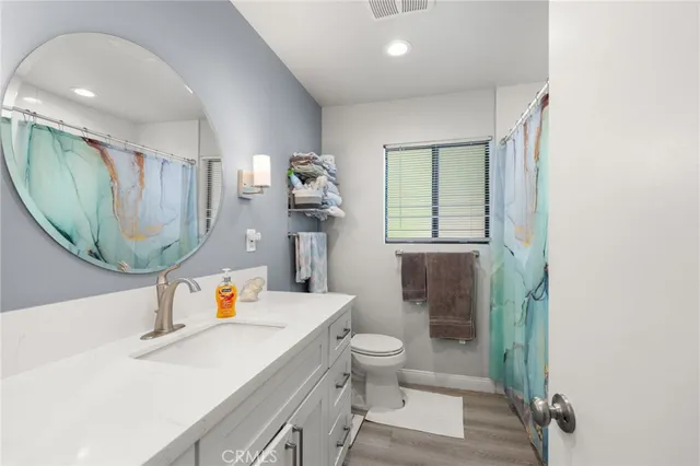 a bathroom with a sink toilet and mirror