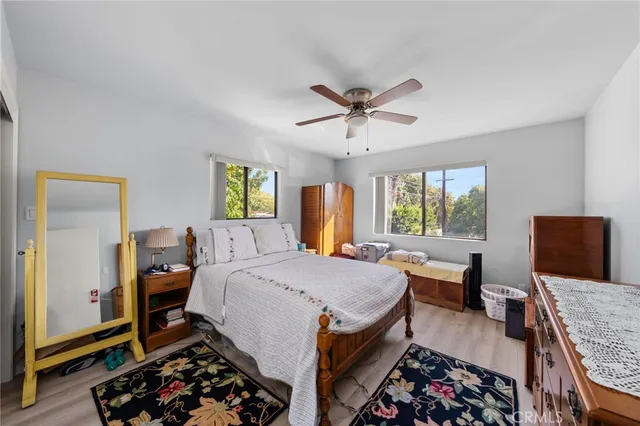 a bed room with a bed a couch and a window