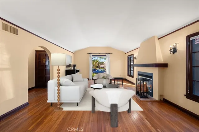 a living room with fireplace furniture and a wooden floor