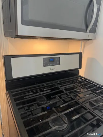wooden floor in an empty room and a kitchen