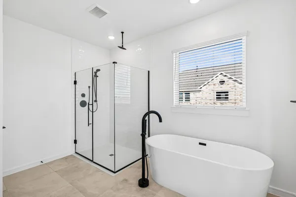 a spacious bathroom with a double vanity sink a mirror and a bathtub