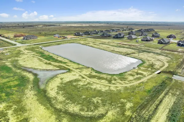 a view of a lake with houses in the back