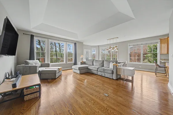 a living room with furniture flat screen tv and a large window