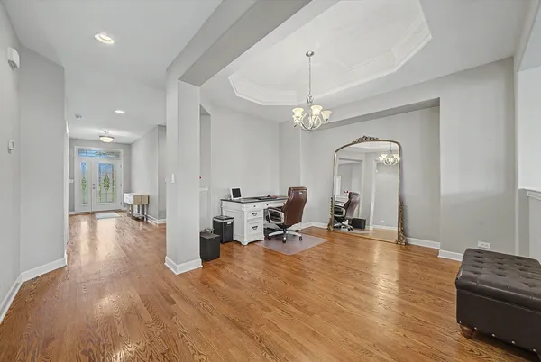 a living room with furniture and a chandelier