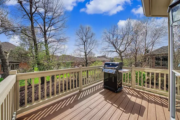 a view of a balcony with wooden floor and fence