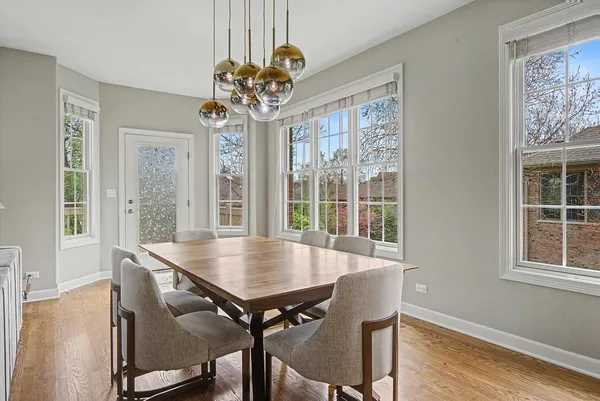 a view of a dining room with furniture wooden floor and chandelier