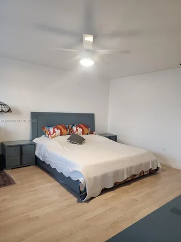 a bedroom with a bed and a night stand