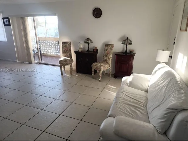 a living room with furniture and white walls