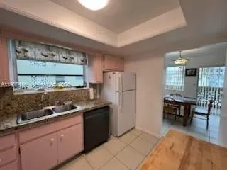 a kitchen with stainless steel appliances granite countertop a refrigerator and a stove