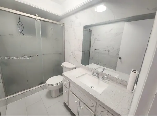 a bathroom with a sink toilet and shower