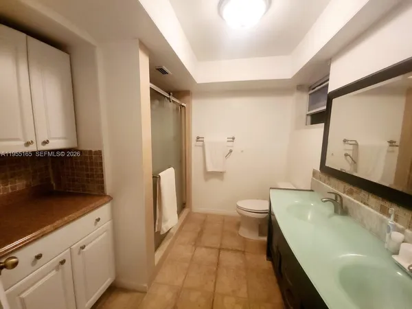 a bathroom with a sink toilet and shower