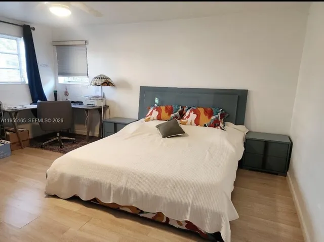 a bedroom with a bed and window