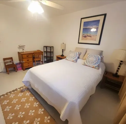 a bedroom with bed and cupboard