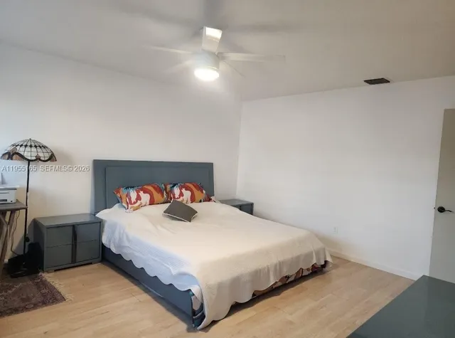 a bedroom with a bed and a night stand