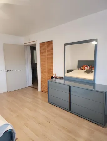 a room with a bed and a dresser
