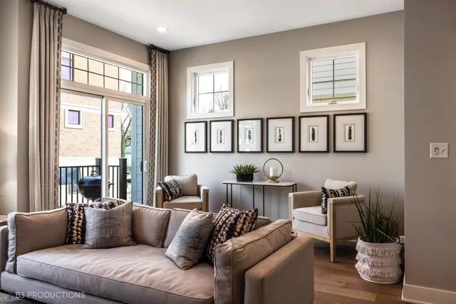 a living room with furniture and two windows