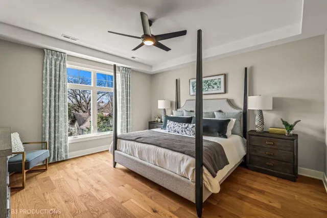 a bedroom with a large bed and a chandelier