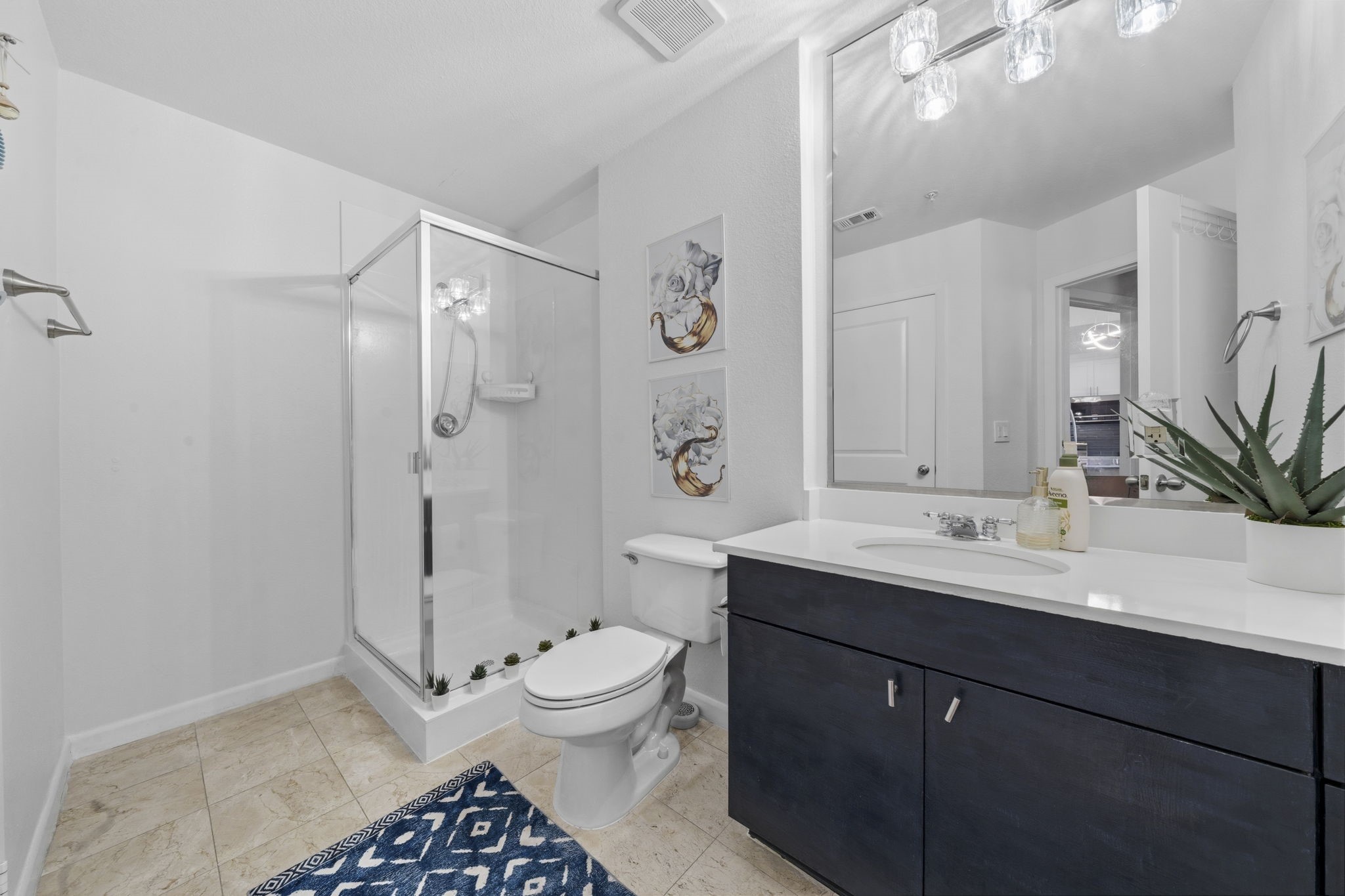 3505 Sage Road, Unit 1905 Houston, TX 77056 - Photo 11 of 15 a bathroom with a sink a toilet a mirror and shower