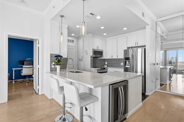 a kitchen with kitchen island a refrigerator stove microwave and cabinets