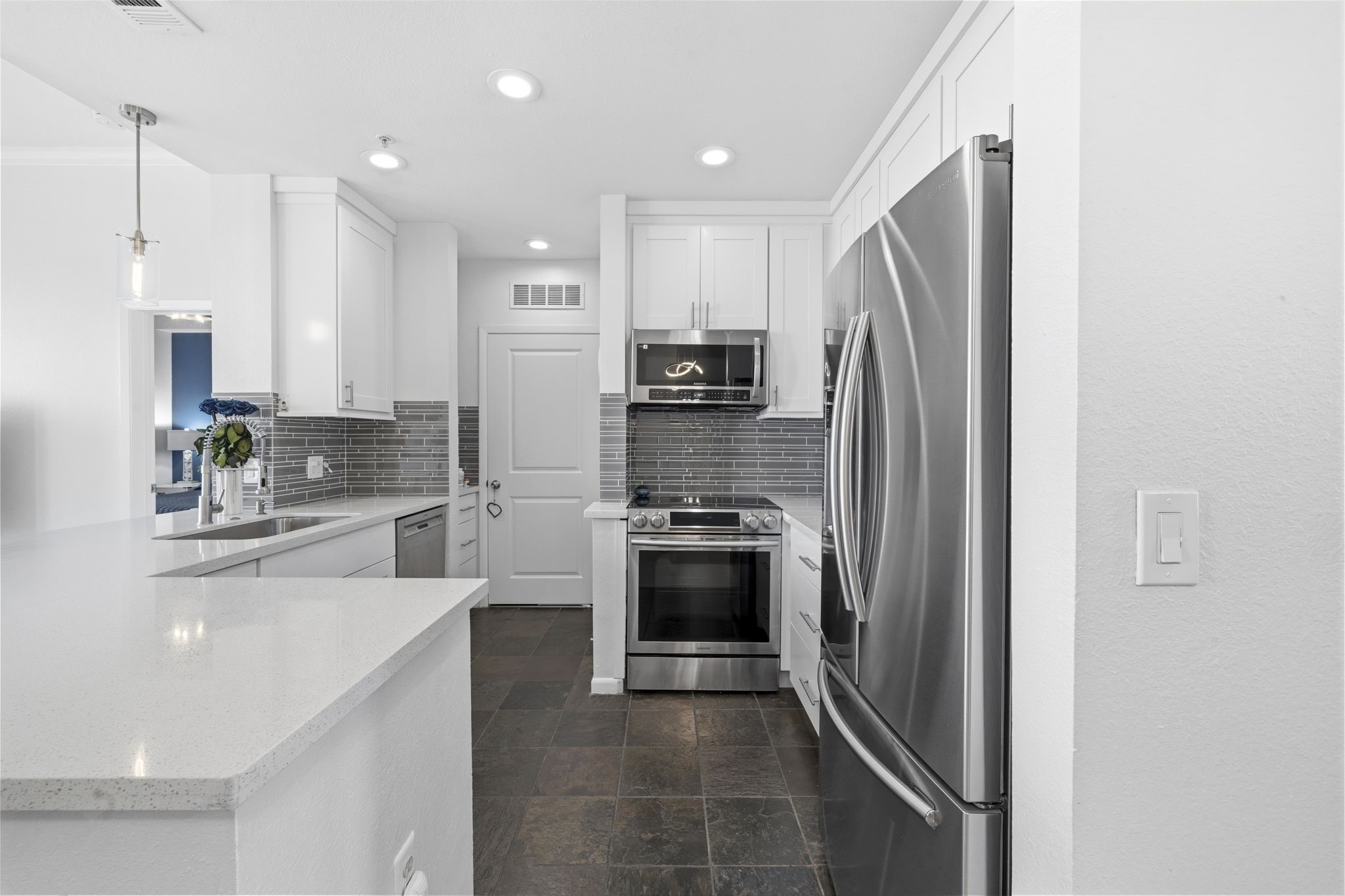 3505 Sage Road, Unit 1905 Houston, TX 77056 - Photo 5 of 15 a kitchen with stainless steel appliances a refrigerator sink and cabinets