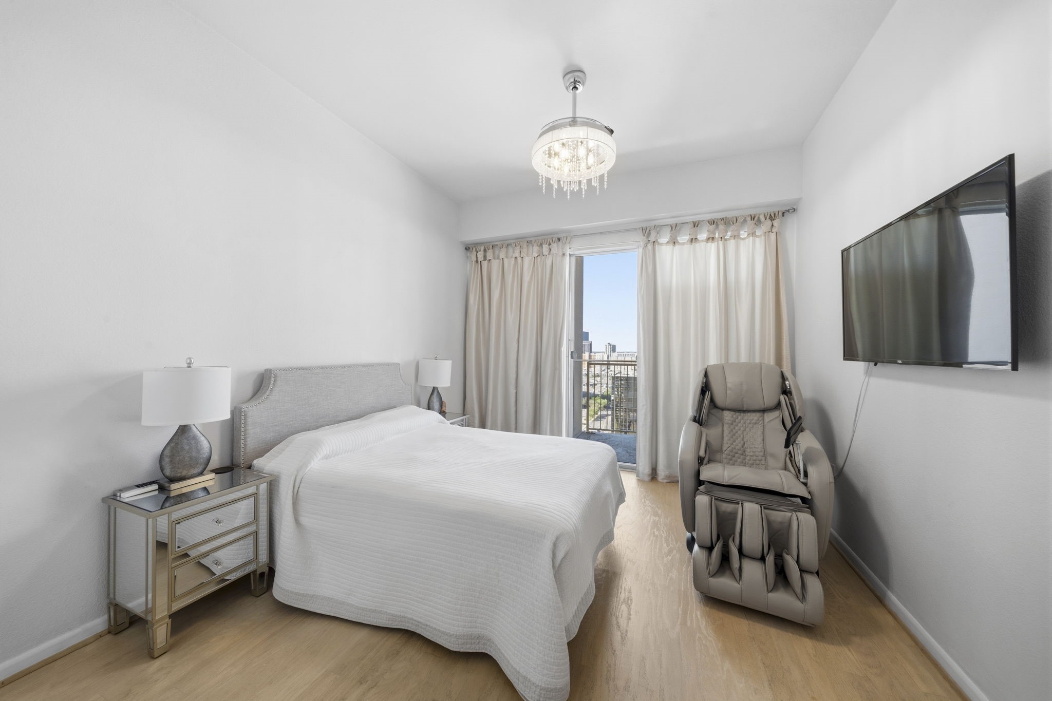 3505 Sage Road, Unit 1905 Houston, TX 77056 - Photo 10 of 15 a bedroom with a bed and a chandelier