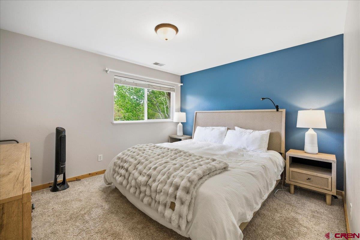 520 Redcliff Circle, Unit G203 Ridgway, CO 81432 - Photo 7 of 25 a bedroom with a bed and a window