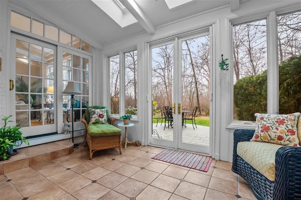 a bedroom with furniture and large windows