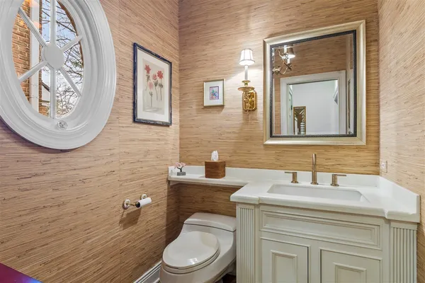 a bathroom with a toilet a sink and mirror