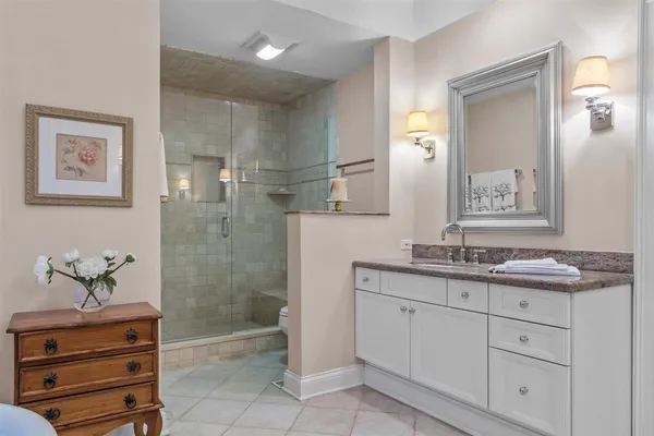 a spacious bathroom with a granite countertop sink a mirror and a