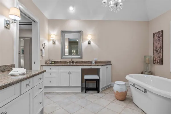 a bathroom with a granite countertop toilet sink and mirror