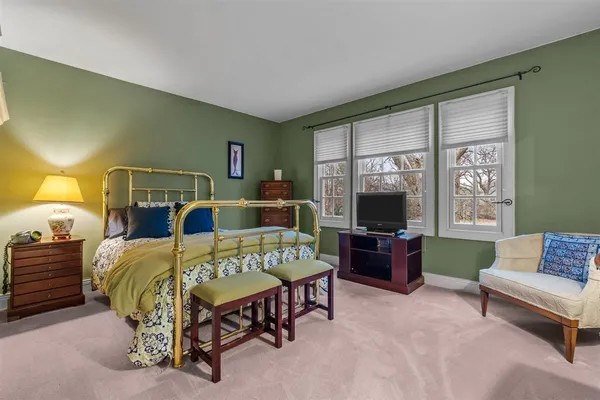 a bedroom with a bed and a couch