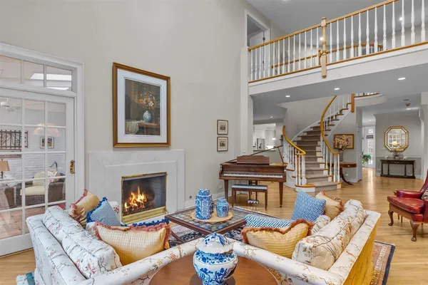 a living room with furniture a fireplace and a large window