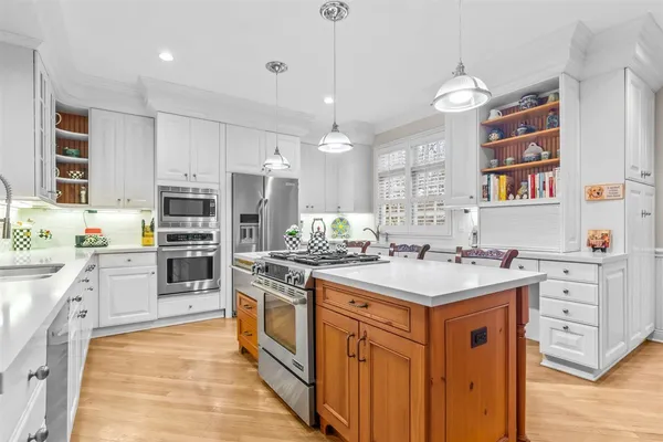 a kitchen with stainless steel appliances a sink stove and refrigerator