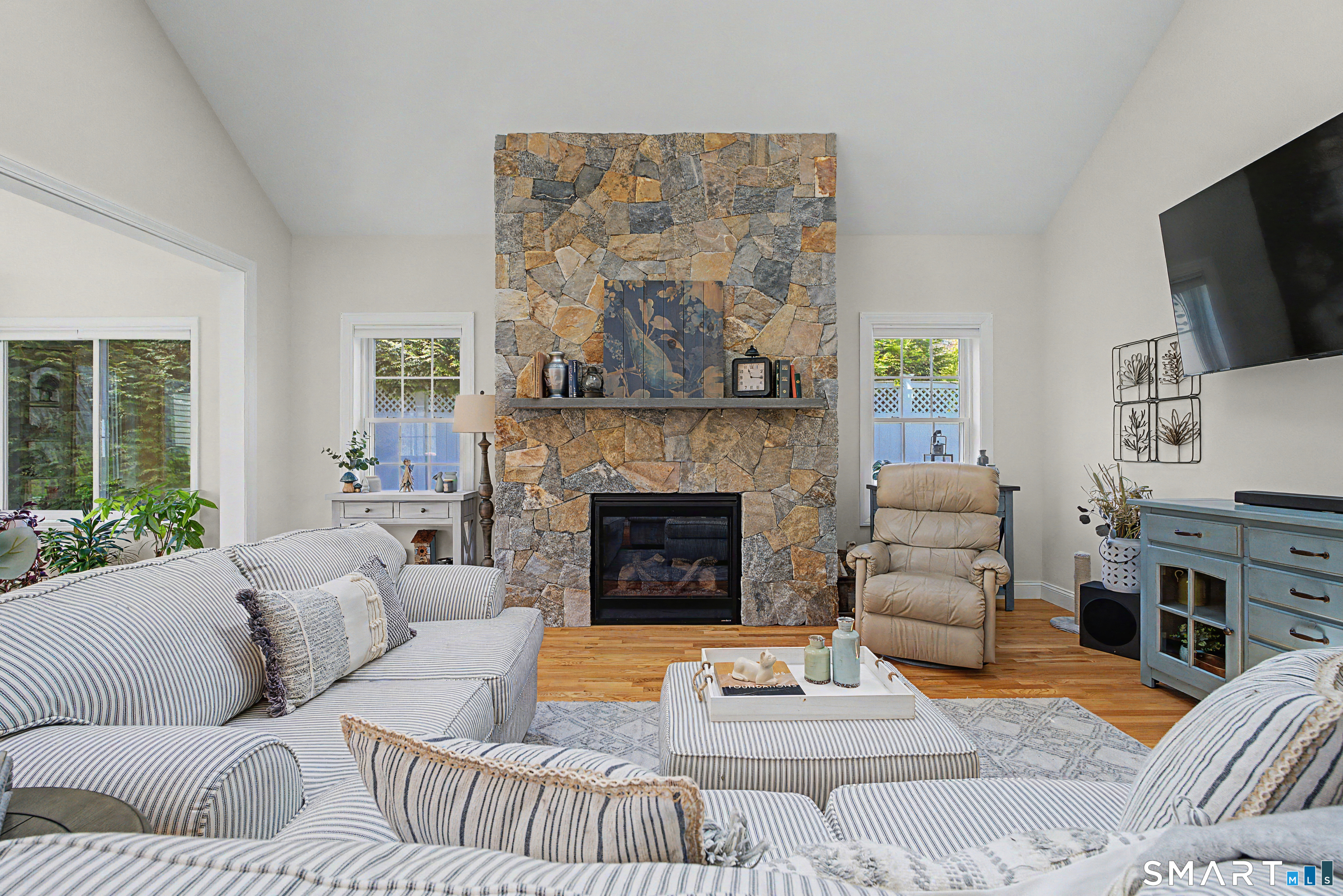 211 Meadowbrook Road, Unit 211 Oxford, CT 06478 - Photo 5 of 38 Inviting open-concept living space with dramatic stone fireplace and vaulted ceilings-perfect for relaxing or entertaining.