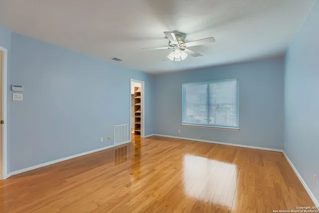 a bathroom with a granite countertop sink a toilet a mirror and bathtub