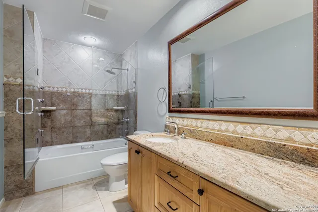 a view of a room with wooden floor and fan