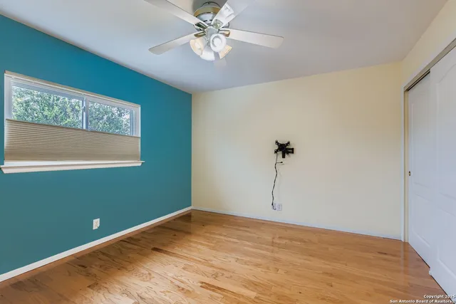 a view of empty room with wooden floor