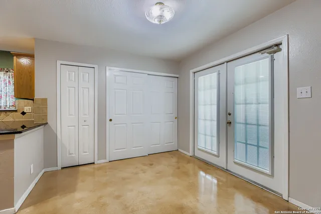 a view of a dining room with furniture and a window