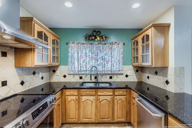 a kitchen that has a sink and a stove in it