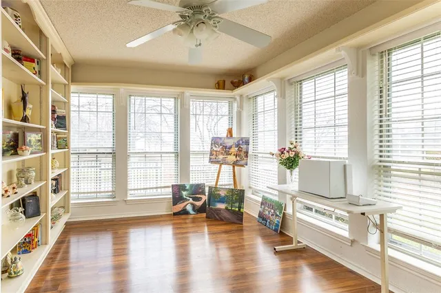 a living room with furniture and a large window with wooden floor