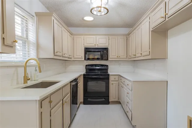 a kitchen with sink a microwave and stove