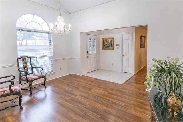 a view of a livingroom with furniture wooden floor and a chandelier