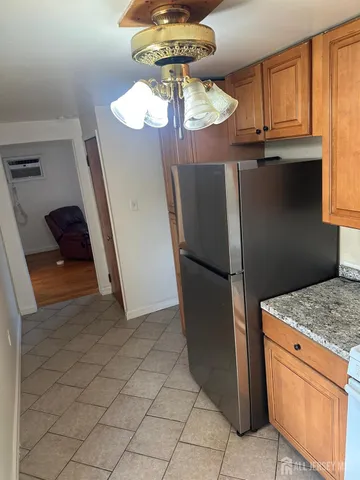a kitchen with stainless steel appliances granite countertop a refrigerator and a stove