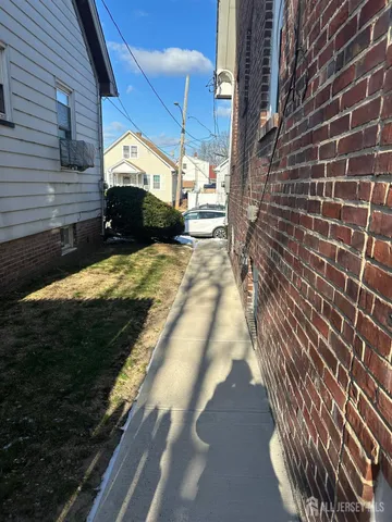 a view of a pathway both side of house