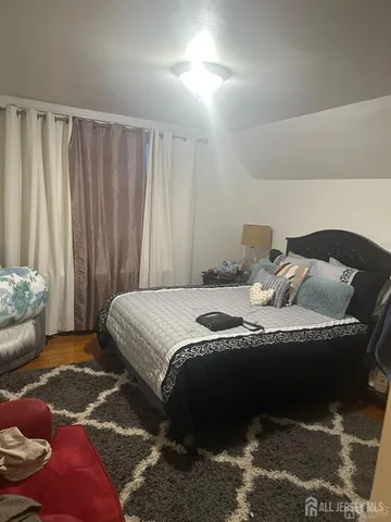 a bedroom with a bed and curtain