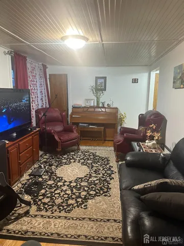 a living room with furniture and a rug