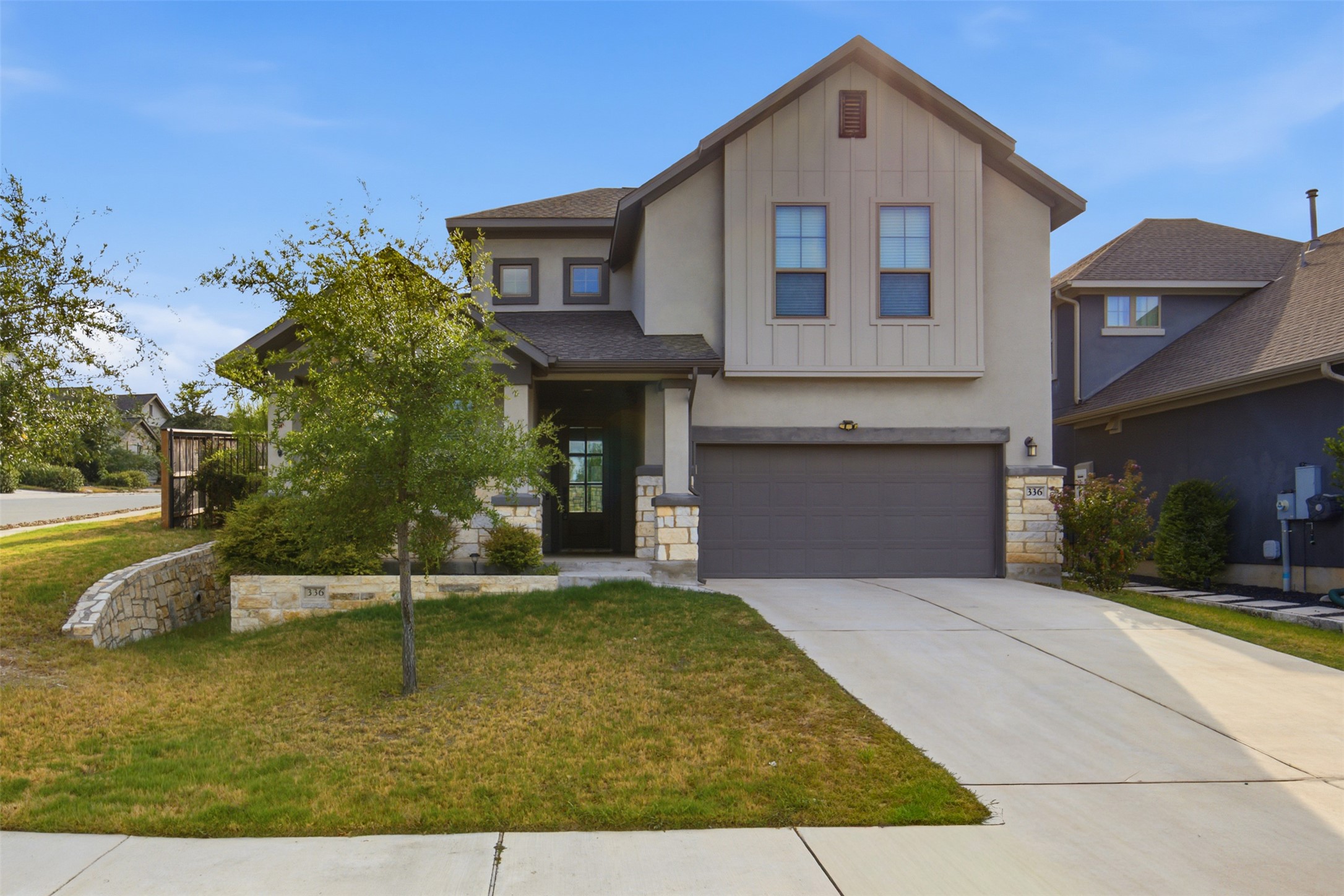 336 Berkeley Place Georgetown, TX 78628 - Photo 2 of 37 Board and batten siding pairs beautifully with stone accents along this two-story exterior.