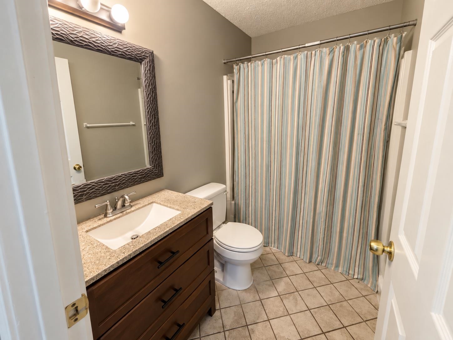3771 West Union Road Millington, TN 38053 - Photo 12 of 16 Vanity with a granite-style countertop, undermount sink, and dark wood-finish cabinetry